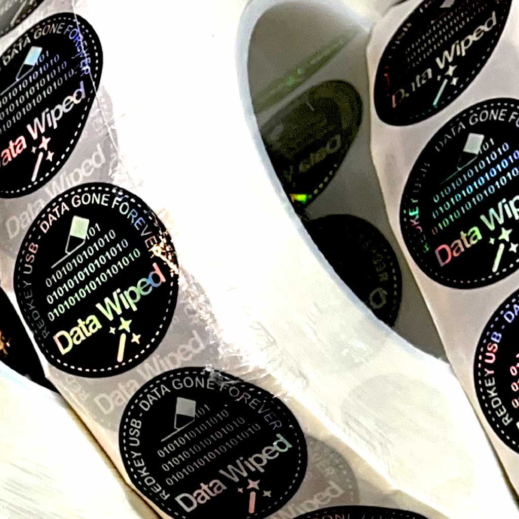 Data Wiped Stickers - Roll of 5,000: close-up of holographic stickers on the roll
