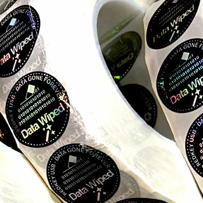 Data Wiped Stickers - Roll of 5,000: close-up of holographic stickers on the roll