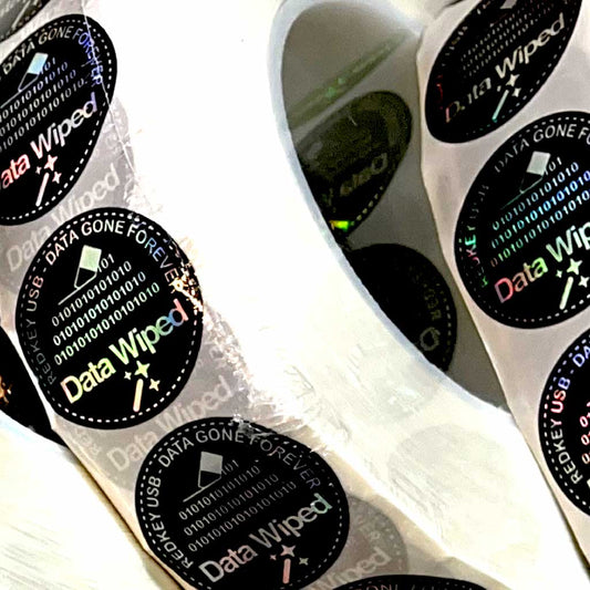 Data Wiped Stickers - Roll of 5,000: close-up of holographic stickers on the roll